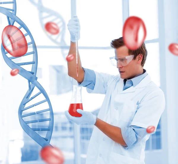 Serious scientist putting chemicals in a test-tube — Stock Photo, Image