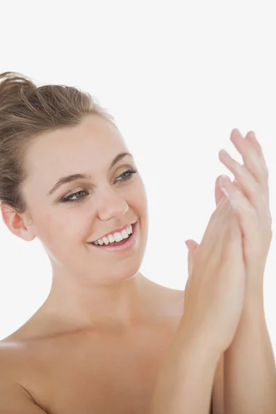 Woman applying moisturizer on hands — Stock Photo, Image