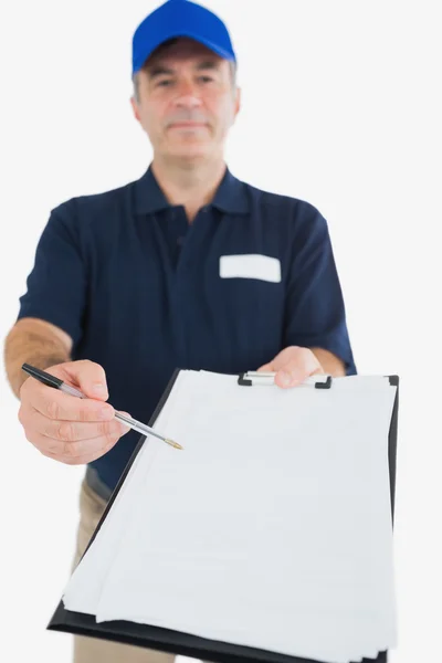 Delivery man holding out clipboard for signature — Stock Photo, Image