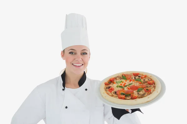 Happy female chef holding pizza — Stock Photo, Image