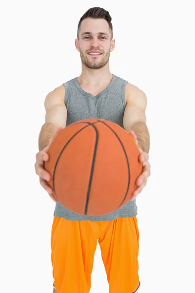 Portrait of happy young man holding basketball — Stok Foto