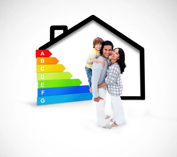 Smiling family standing with a black house illustration with ene — Stock Photo, Image