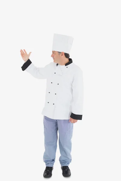 Confident chef showing something on white — Stock Photo, Image