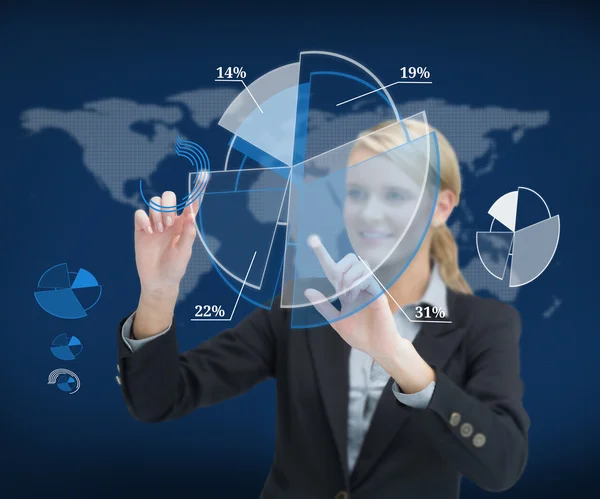 Smiling businesswoman touching screen with graphs — Stock Photo, Image