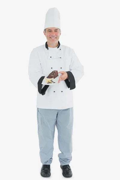 Happy chef offering chocolate pastry — Stock Photo, Image