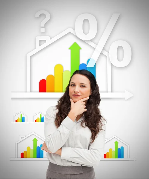 Woman standing against energy efficient house graphic — Stock Photo, Image