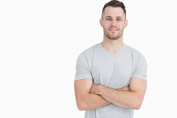 Portrait of casual young man standing with arms crossed — Stock Photo, Image
