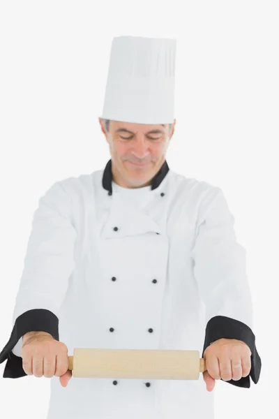 Man in chef uniform using rolling pin — Stock Photo, Image