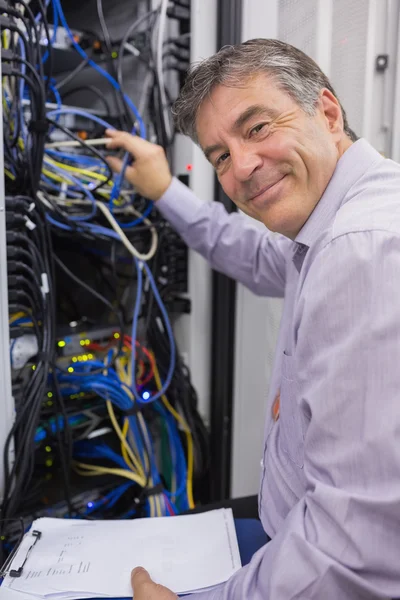 Técnico sonriente comprobando el servidor —  Fotos de Stock