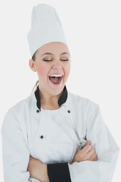 Chef holding wire whisk as she laughs — Stock Photo, Image