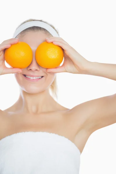 Frau hält Orangen vor Augen — Stockfoto