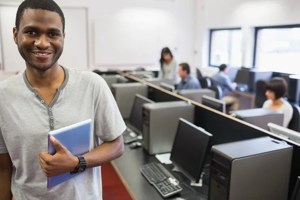 Student in computer room holding tablet pc — Stock Photo, Image