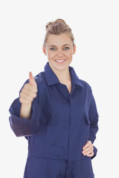 Female technician witth hand on waist showing thumbs up sign — Stock Photo, Image