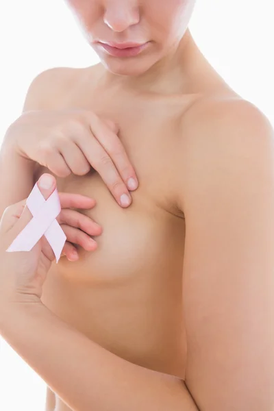 Naked woman holding breast cancer ribbon — Stock Photo, Image