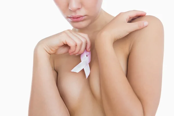 Naked woman holding breast cancer awareness ribbon — Stock Photo, Image