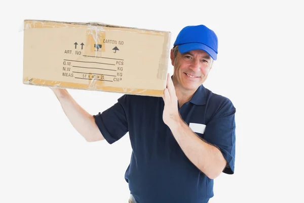 Happy delivery man carrying package — Stock Photo, Image