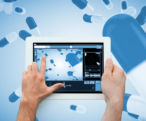 Hand holding and touching a digital tablet — Stock Photo, Image