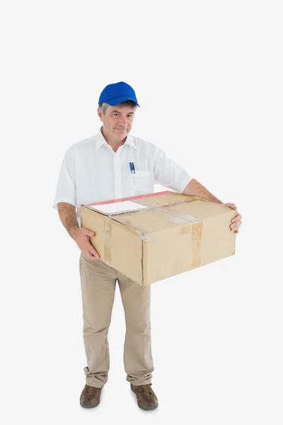 Courier man carrying cardboard box — Stock Photo, Image