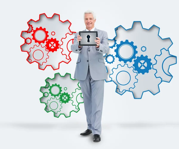 Smiling businessman standing against a background — Stock Photo, Image