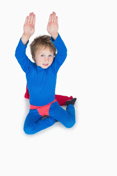 Boy dressed as superhero and raising arms — Stock Photo, Image