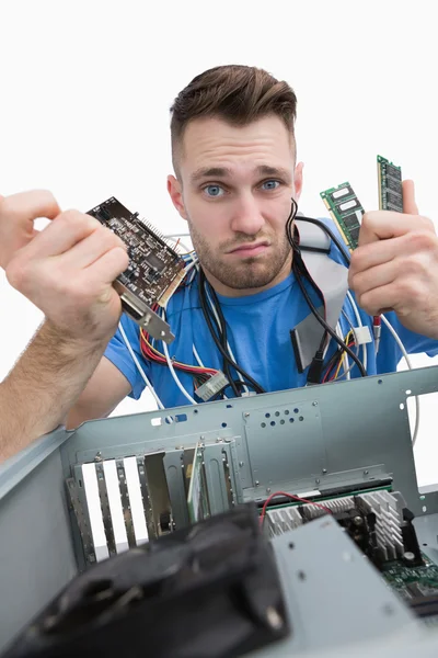 Portrait of confused it professional with chips in front of open — Stock Photo, Image