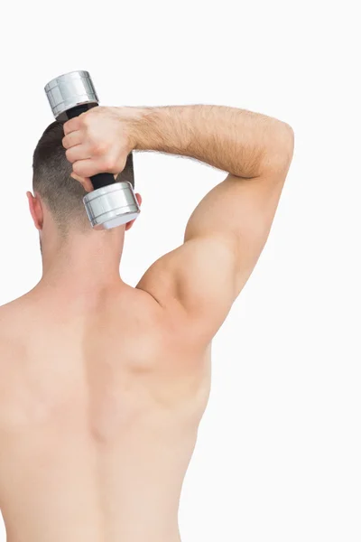 Rear view of man exercising with dumbbell — Stock Photo, Image