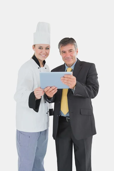 Female chef and businessman with digital tablet — Stock Photo, Image