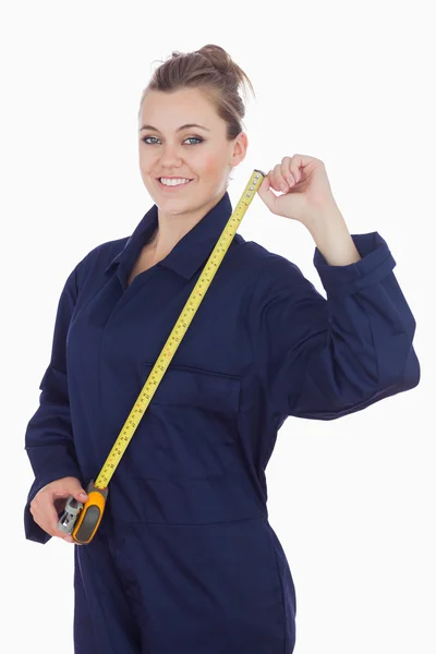 Female mechanic with measuring tape — Stock Photo, Image