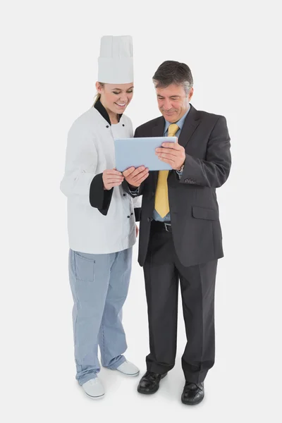 Businessman and chef using digital tablet — Stock Photo, Image