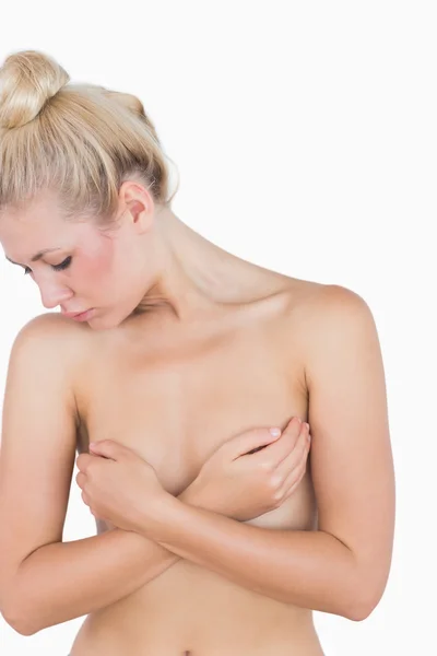 Naked woman covering her breasts with hands — Stock Photo, Image