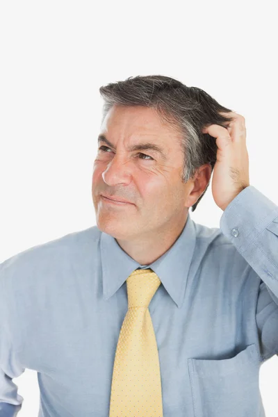 Confused businessman scratching head — Stock Photo, Image