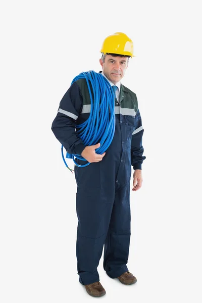 Portrait of mature repairman with large wire and hardhat — Stock Photo, Image