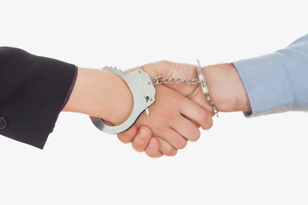 Business in handcuffs shaking hands — Stock Photo, Image