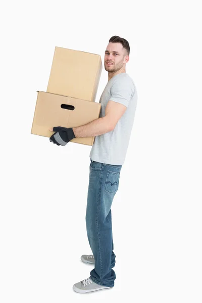 Portrait of young man carrying package boxes — Stock Photo, Image