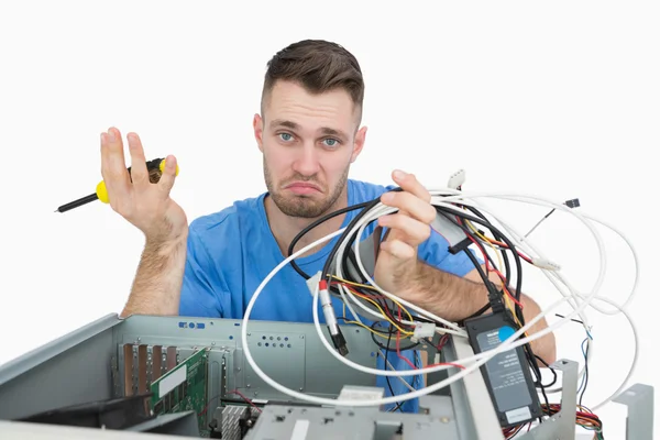 Confused it professional with screw driver and cables in front o — Stock Photo, Image