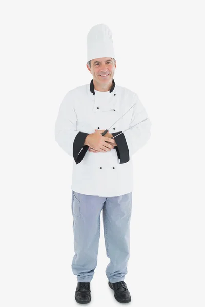 Happy male chef holding tongs — Stock Photo, Image