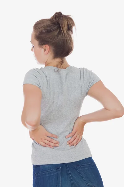 Mujer joven que sufre de dolor de espalda —  Fotos de Stock
