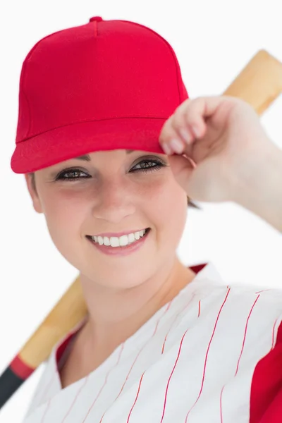 Woman holding a bat and her cap — Stock Photo, Image