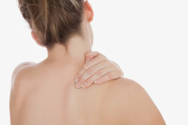 Topless woman massaging back — Stock Photo, Image