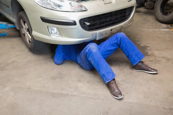Mechanic under car — Stock Photo, Image