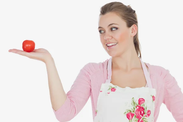 Woman looking at tomato — Stock Photo, Image