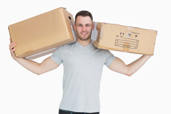 Portrait of young man carrying package boxes — Stock Photo, Image