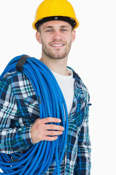 Retrato de sorridente jovem arquiteto masculino carregando enrolada azul tu — Fotografia de Stock