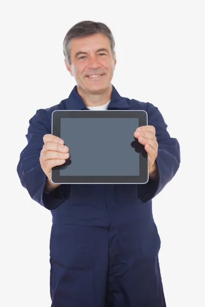 Mature mechanic showing digital tablet — Stock Photo, Image