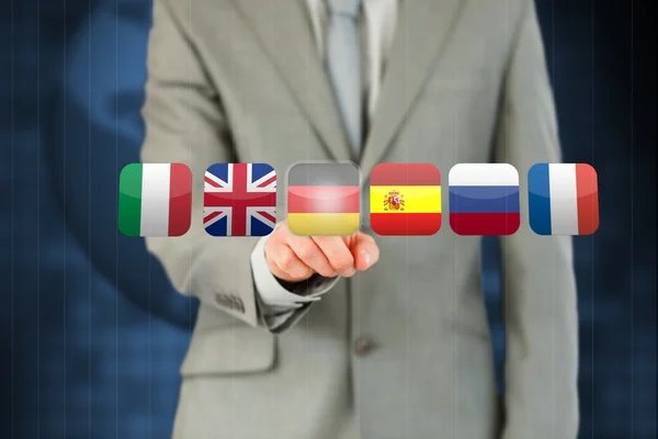 Businessman activating German flag on touchscreen — Stock Photo, Image