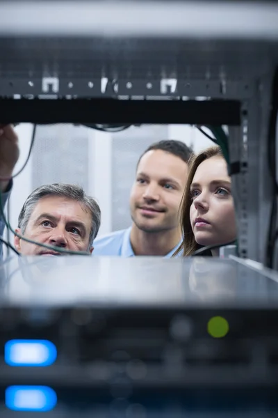 Electricians looking into empty server towers — Stock Photo, Image