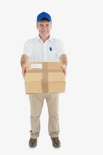 Mature delivery man handing package — Stock Photo, Image