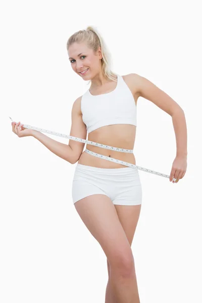 Happy young woman measuring waist — Stock Photo, Image