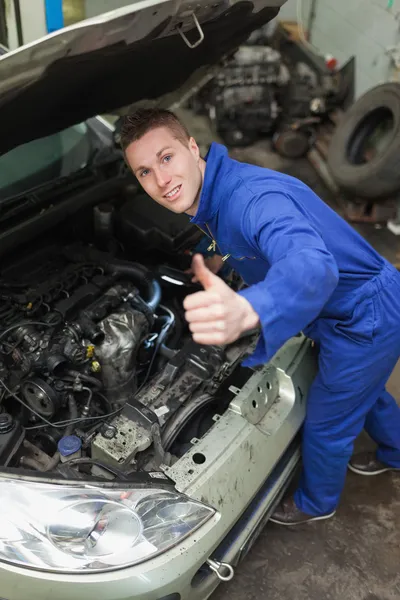 Auto mechanic showing thumbs up sign — Stock Photo, Image