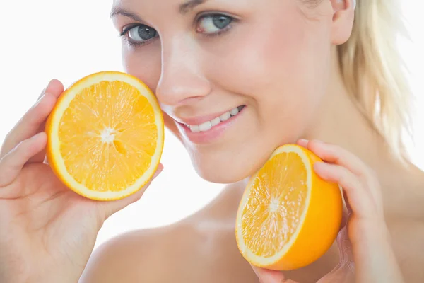 Beautiful woman holding slices of orange — Stock Photo, Image